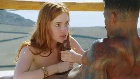 Redheaded teen is giving a handjob and a BJ to a BBC