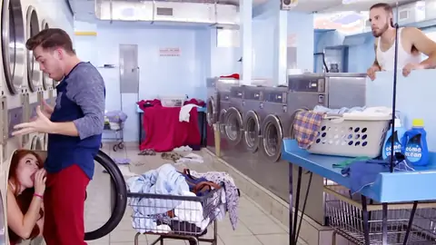 Redhead is giving a blowjob at the laundromat